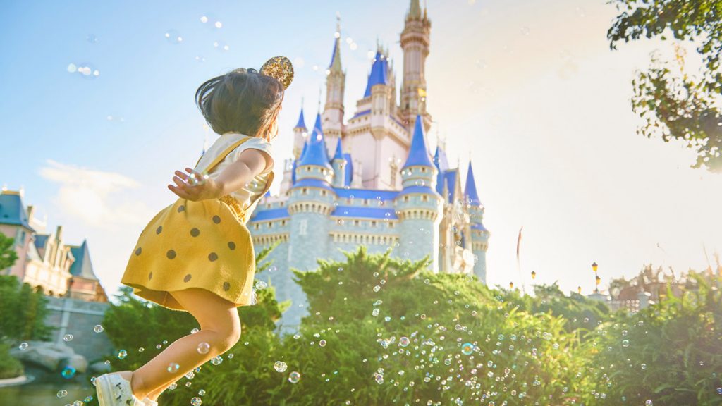 Little girl in front of Disney Castle-2 free Disney Park Ticket Package